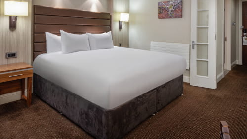Image of a bed in a  hotel room